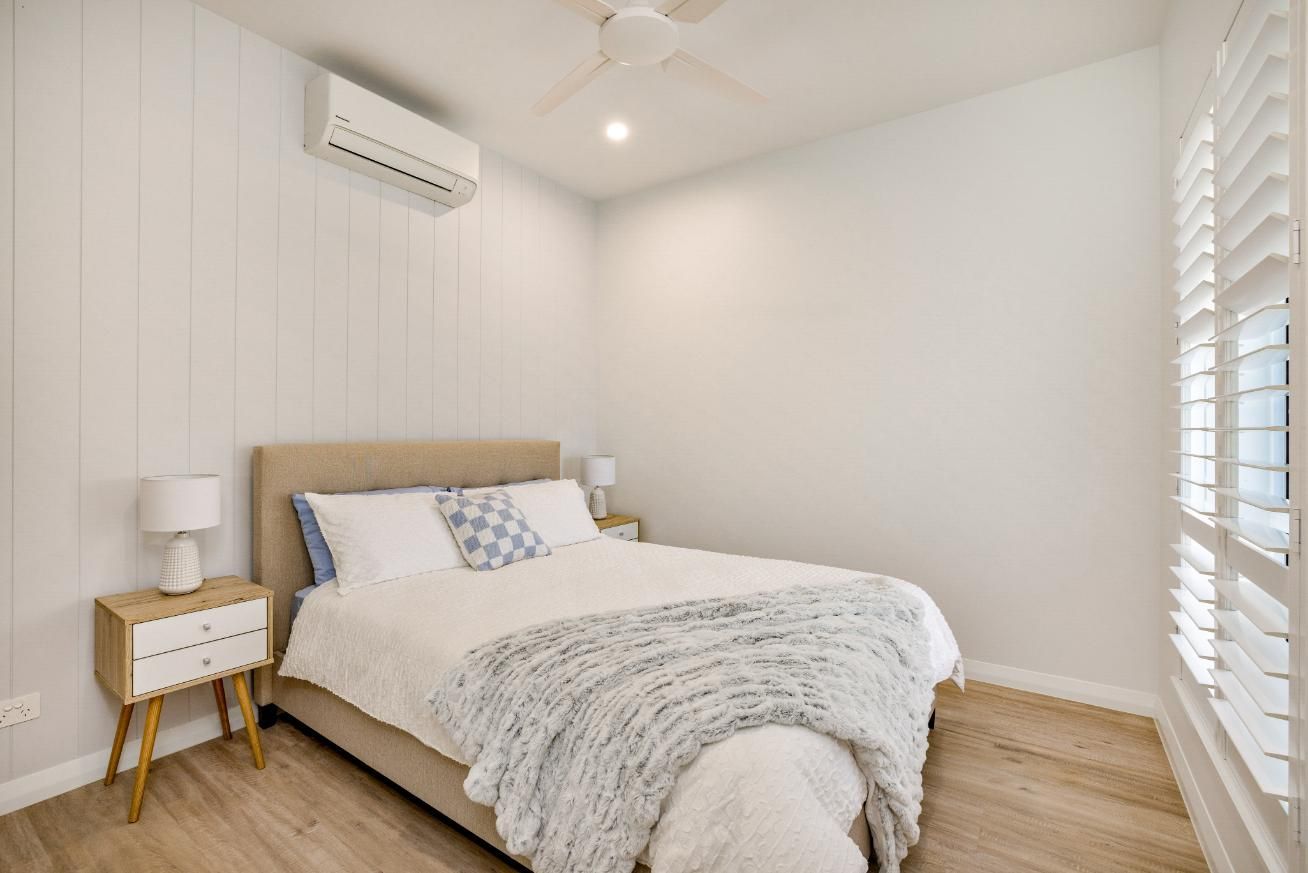 A Bedroom With a Bed, Nightstands, and a Ceiling Fan — Ashlee Jones Homes in Gordonvale, QLD