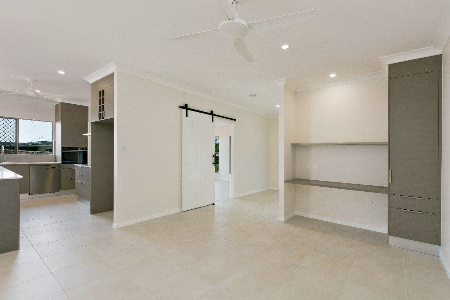 There is a Sliding Barn Door in the Middle of the Room — Ashlee Jones Homes in Gordonvale, QLD