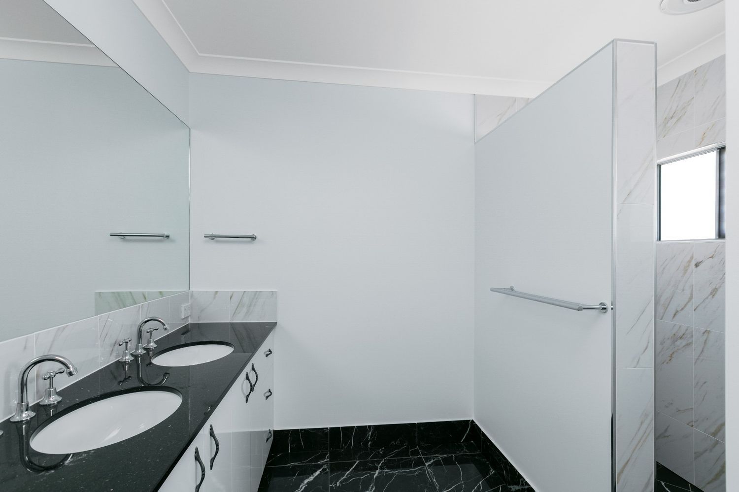 A Bathroom With Two Sinks and a Large Mirror — Ashlee Jones Homes in Gordonvale, QLD