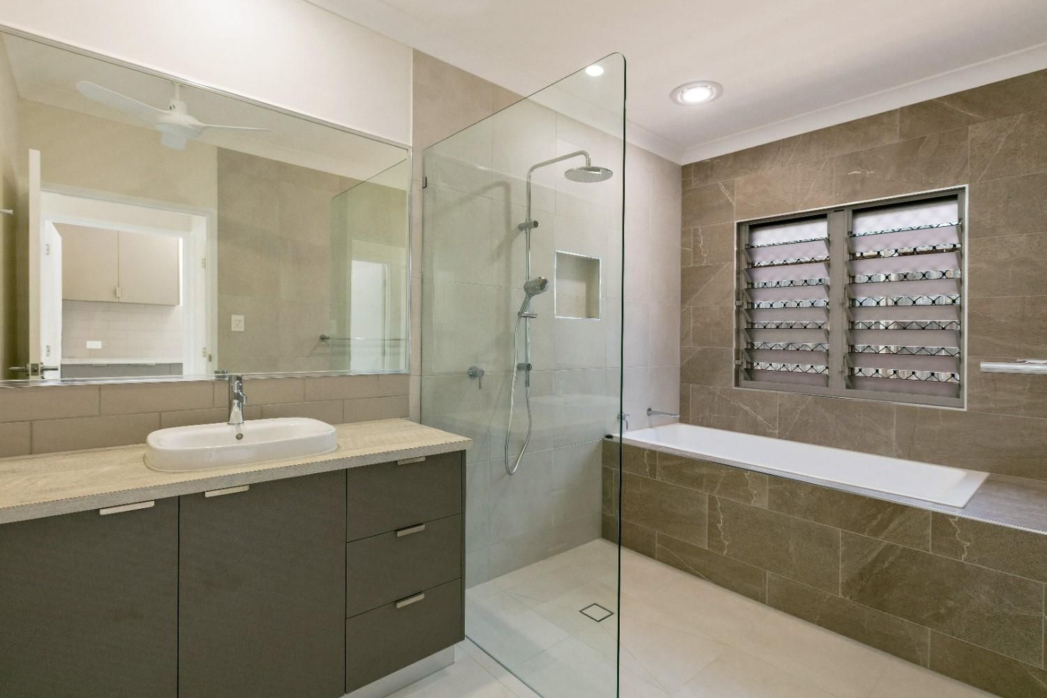 A Bathroom With a Walk in Shower, Sink, and Bathtub — Ashlee Jones Homes in Gordonvale, QLD
