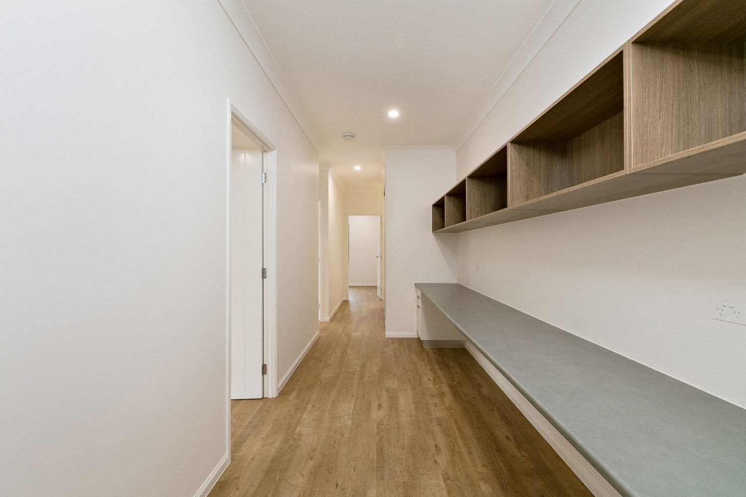 There is a Long Hallway With a Desk and Shelves — Ashlee Jones Homes in Gordonvale, QLD