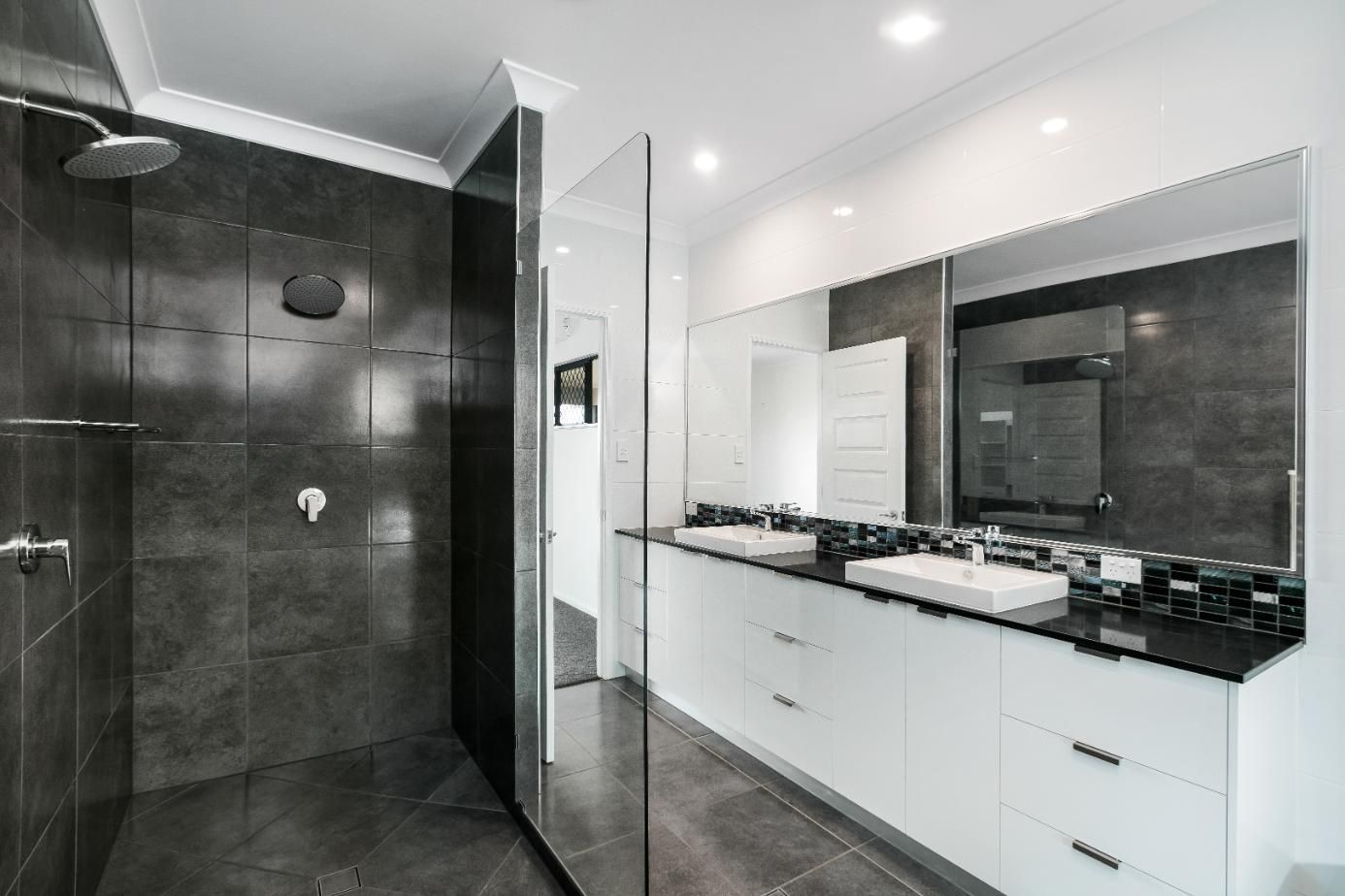 A Bathroom With Two Sinks and a Walk in Shower — Ashlee Jones Homes in Gordonvale, QLD
