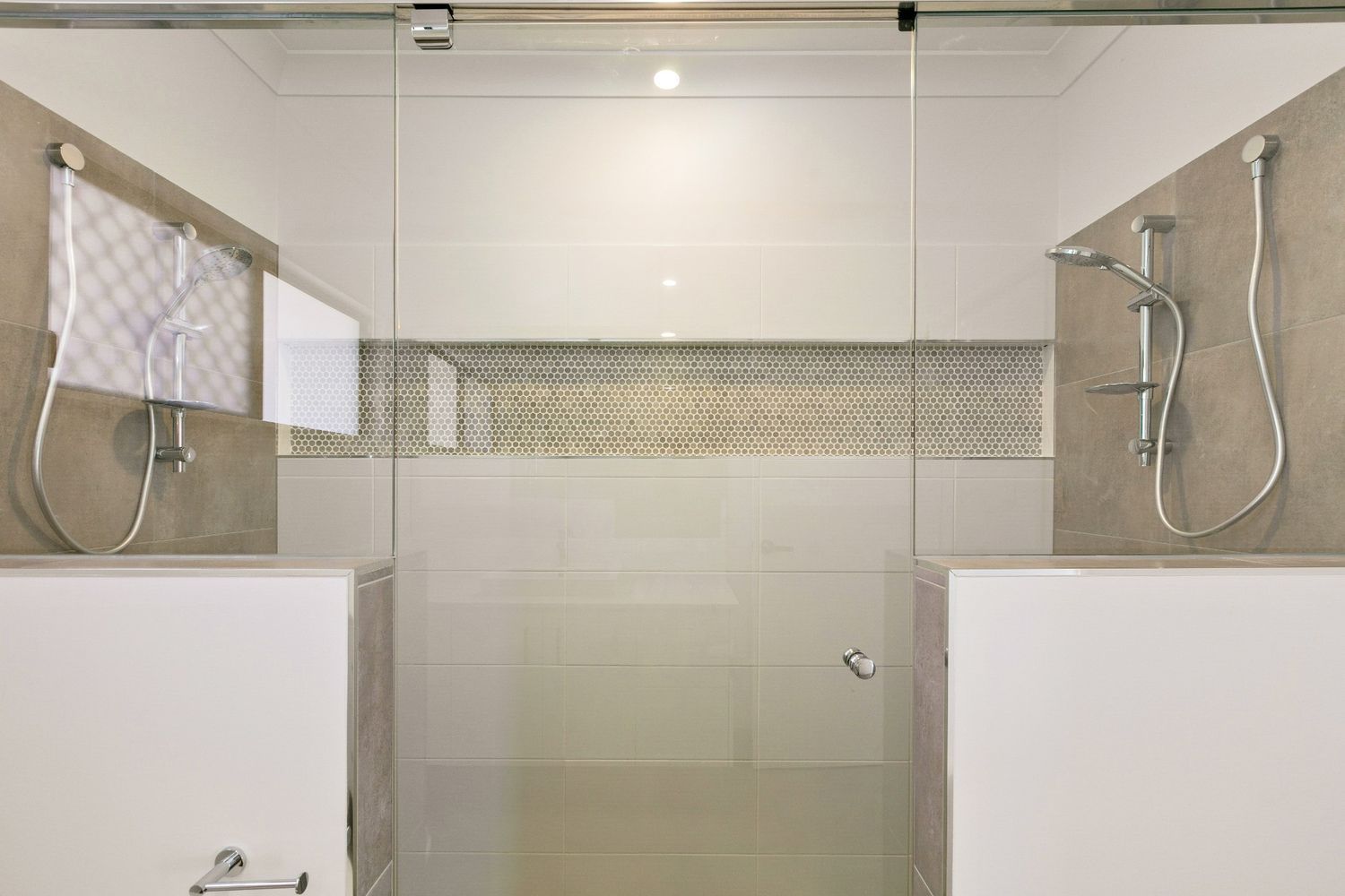 A Bathroom With a Walk in Shower and Two Shower Heads — Ashlee Jones Homes in Gordonvale, QLD