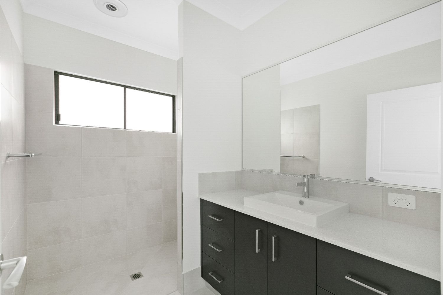 A Bathroom With Two Sinks and a Walk in Shower — Ashlee Jones Homes in Gordonvale, QLD