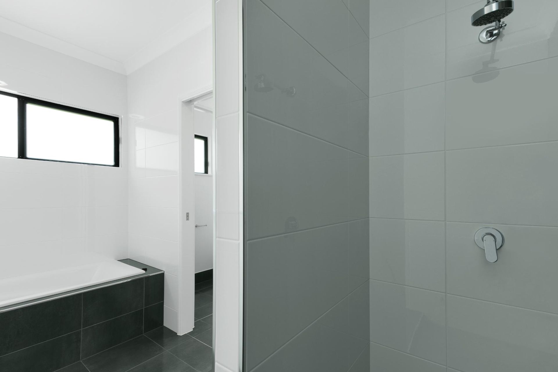 A Bathroom With a Bathtub and a Shower — Ashlee Jones Homes in Gordonvale, QLD