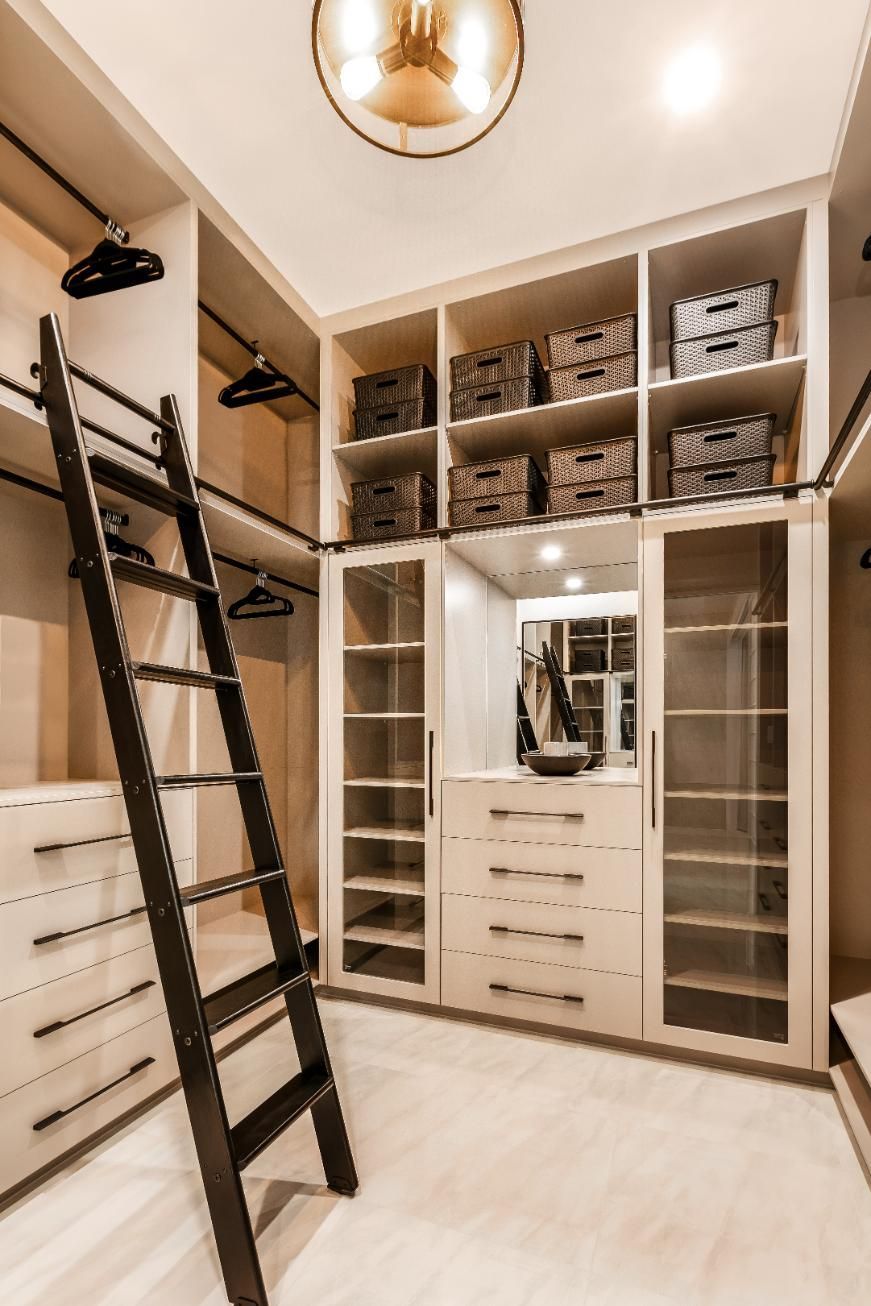 A Walk in Closet With a Ladder and Lots of Shelves — Ashlee Jones Homes in Gordonvale, QLD