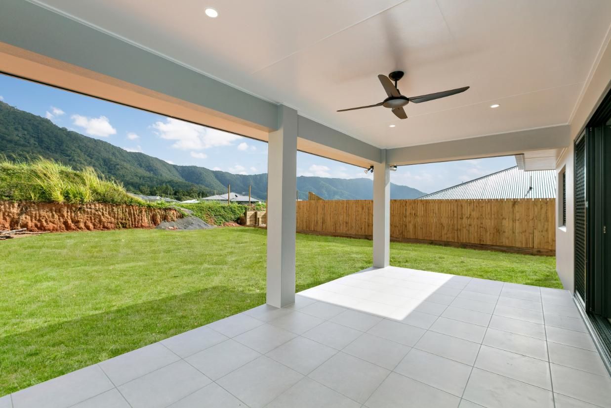 An Empty Patio With a Ceiling Fan and Mountains in the Background — Ashlee Jones Homes in Gordonvale, QLD