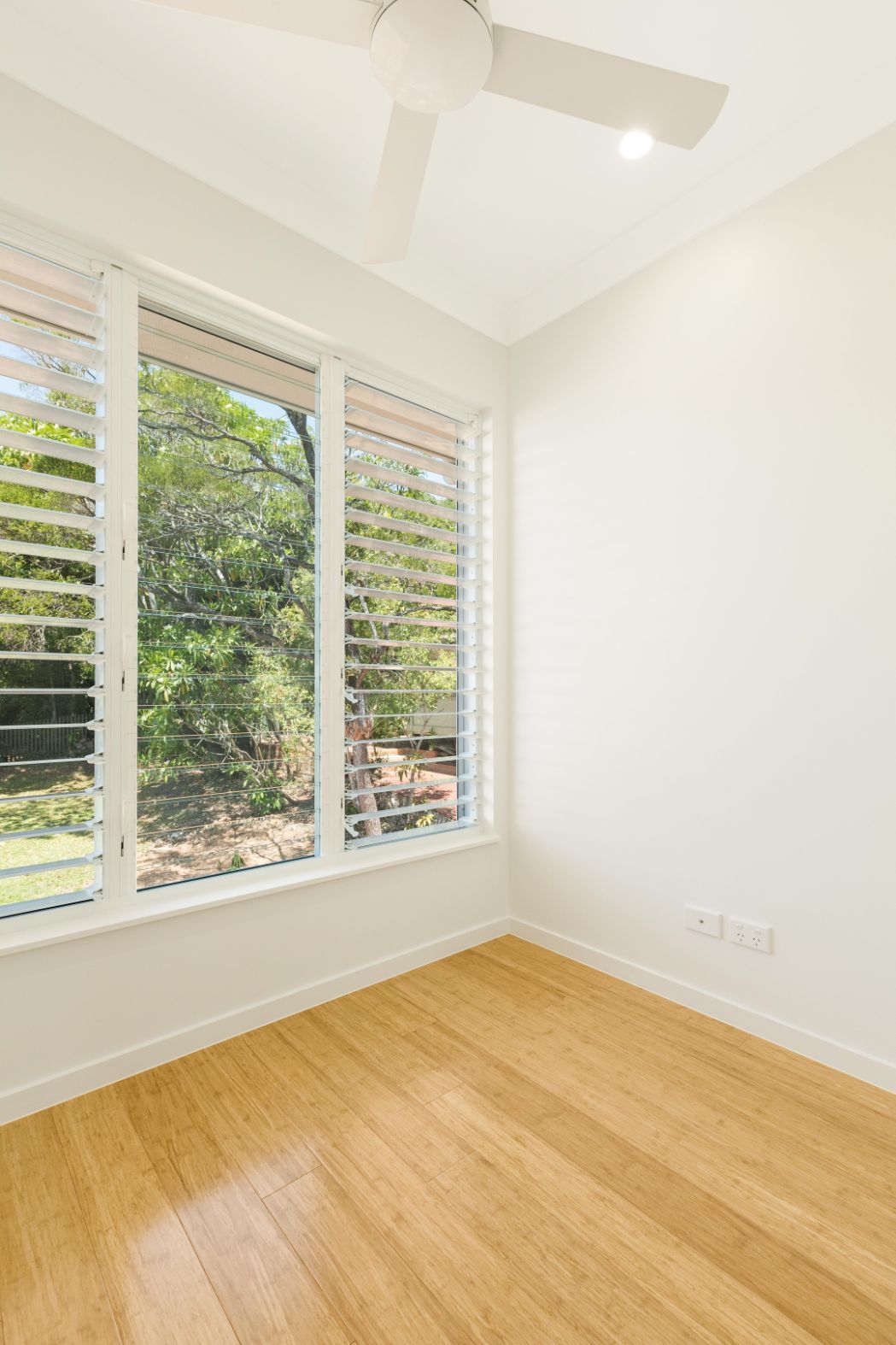 There is a Ceiling Fan in the Room With a Lot of Windows — Ashlee Jones Homes in Gordonvale, QLD