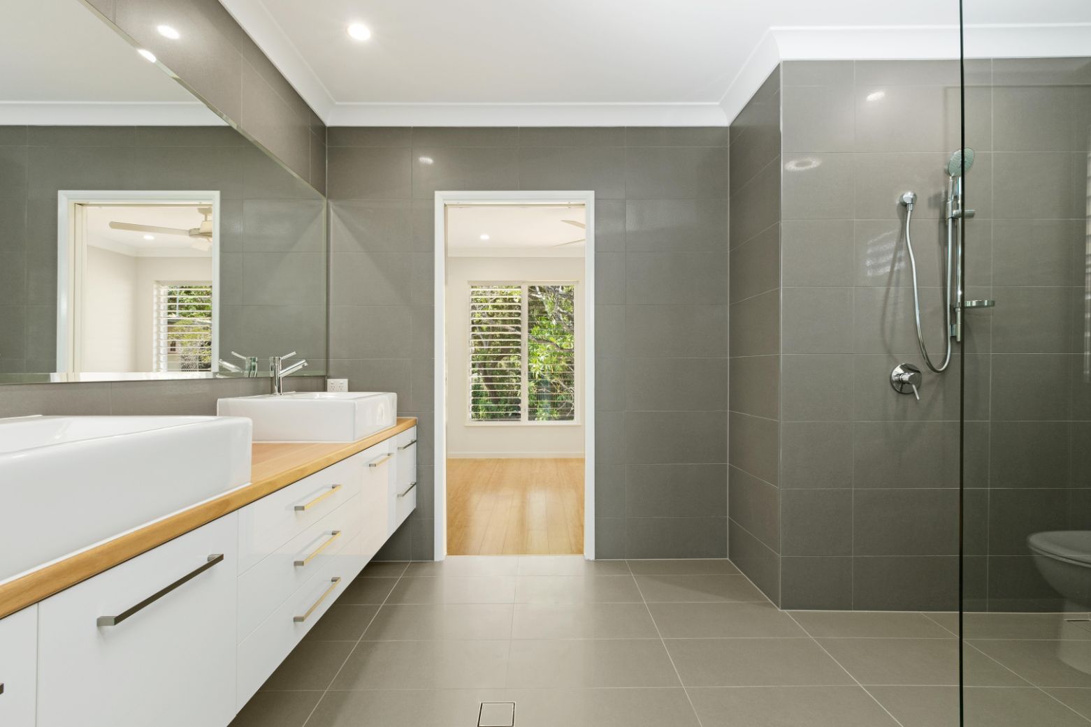 A Bathroom With Two Sinks and a Walk in Shower — Ashlee Jones Homes in Gordonvale, QLD