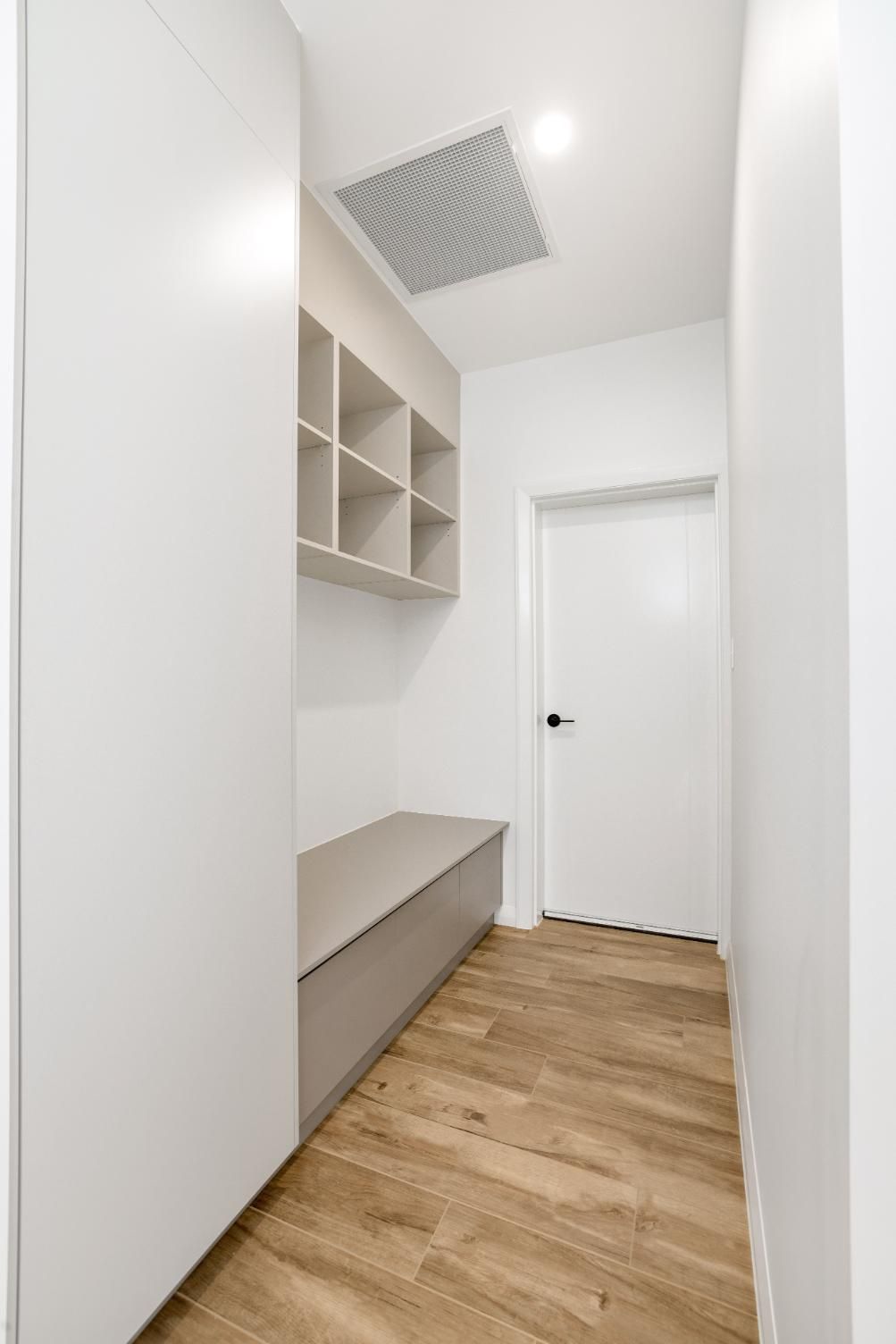 A Hallway With a Bench and Shelves on the Wall — Ashlee Jones Homes in Gordonvale, QLD