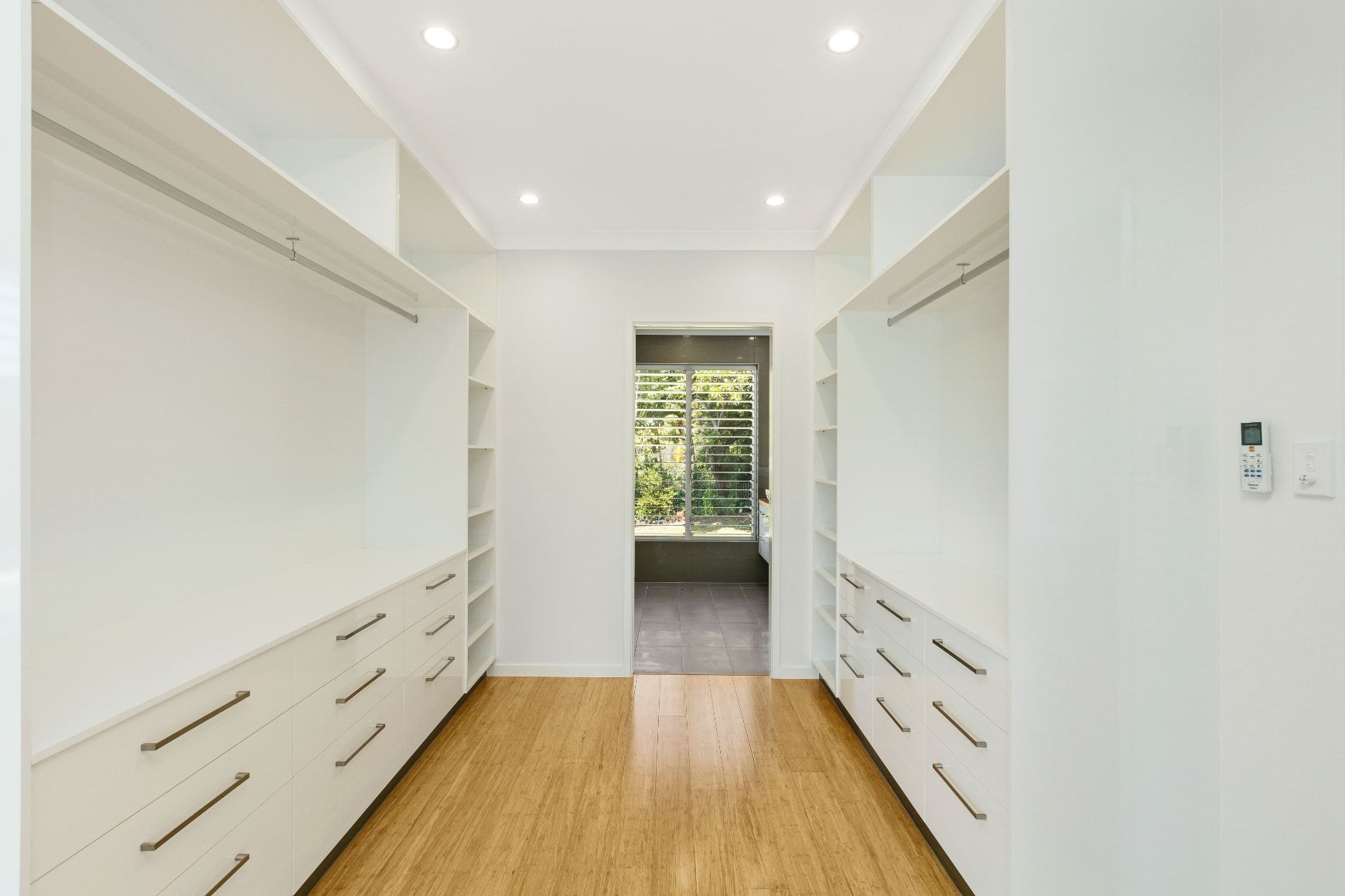 A Walk in Closet With Lots of Drawers and Shelves — Ashlee Jones Homes in Gordonvale, QLD