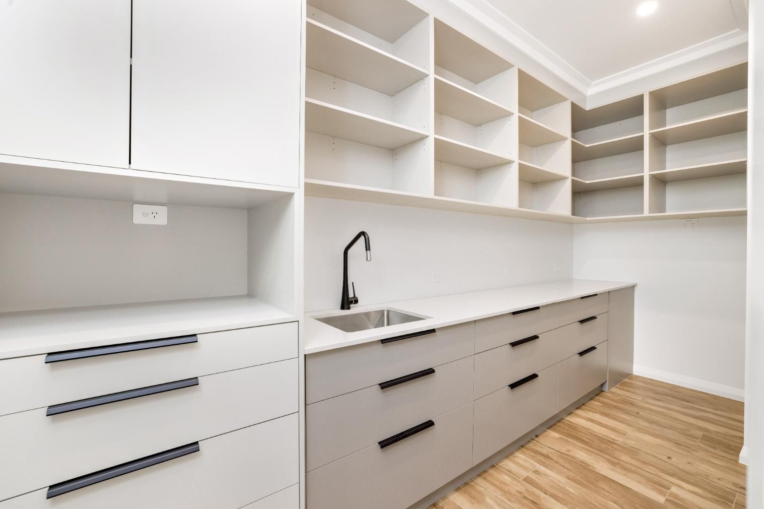 A Kitchen With White Cabinets and Shelves and a Sink — Ashlee Jones Homes in Gordonvale, QLD