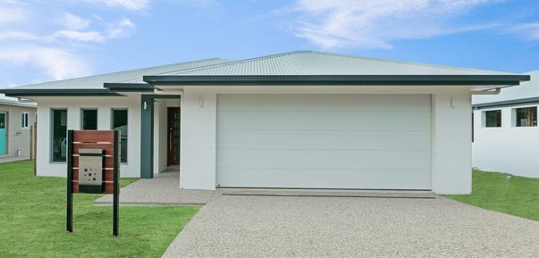 A White House With a White Garage Door and a Mailbox in Front of It — Ashlee Jones Homes in Gordonvale, QLD