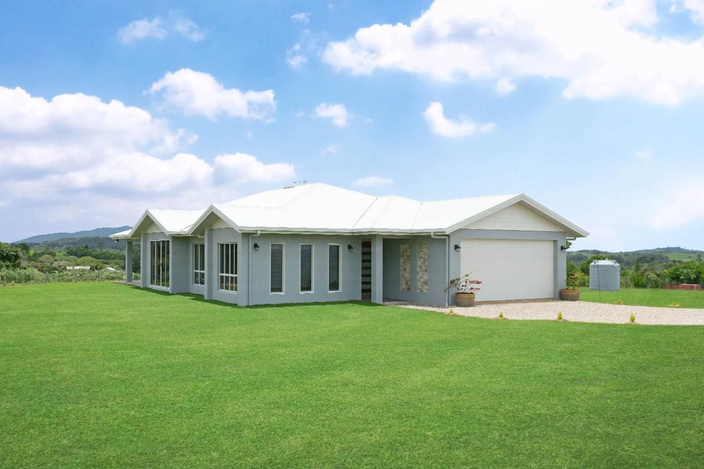 A White House With a Large Lawn in Front of It — Ashlee Jones Homes in Gordonvale, QLD