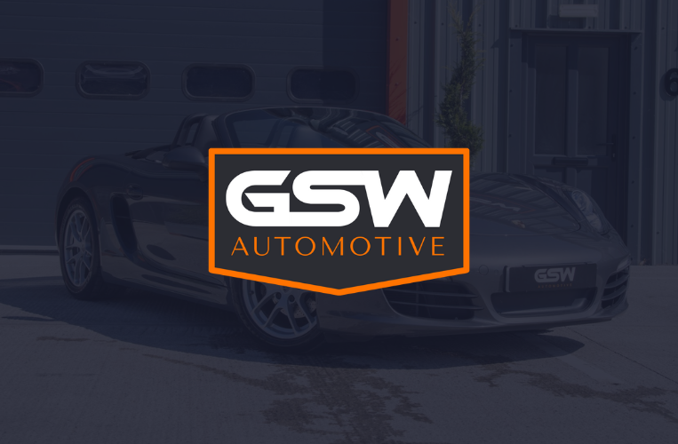 GSW Automotive logo overlaid on a silver sports car in front of a garage.