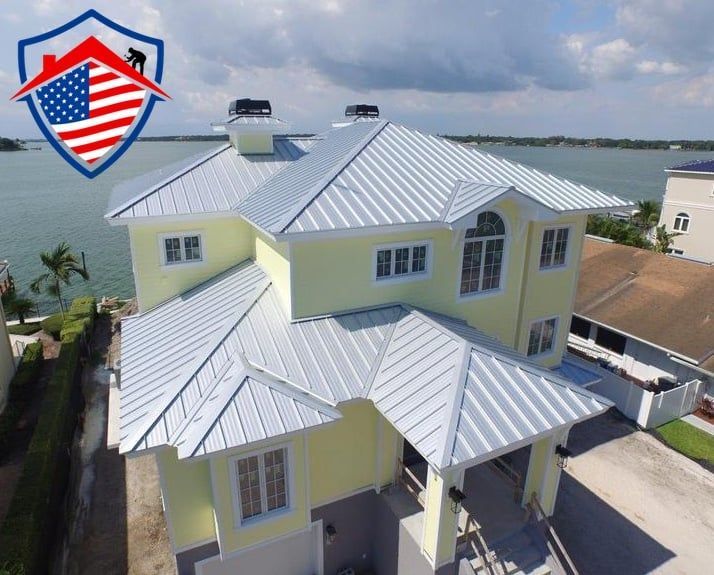 An aerial view of a house with a metal roof