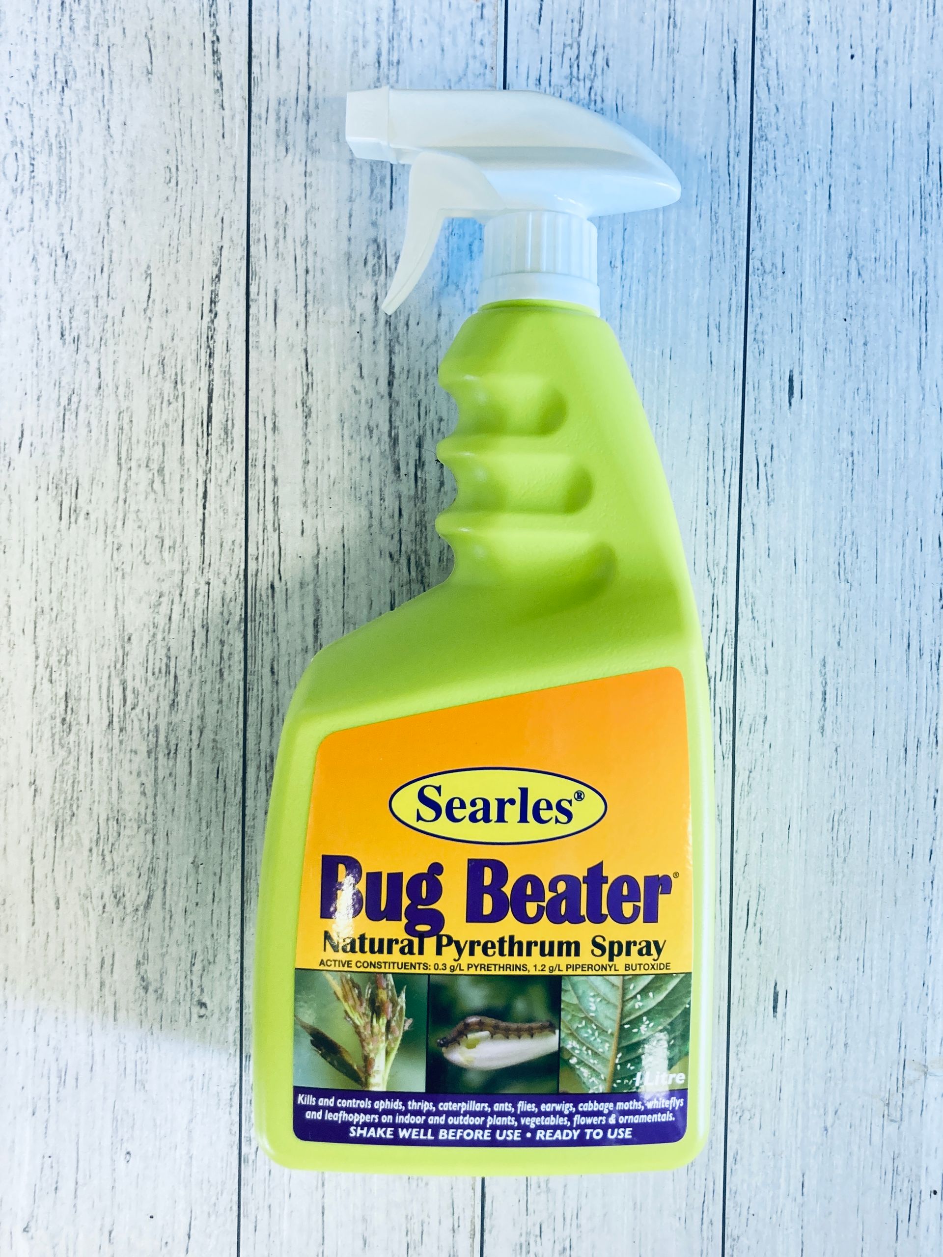 A bottle of searles bug beater spray on a table