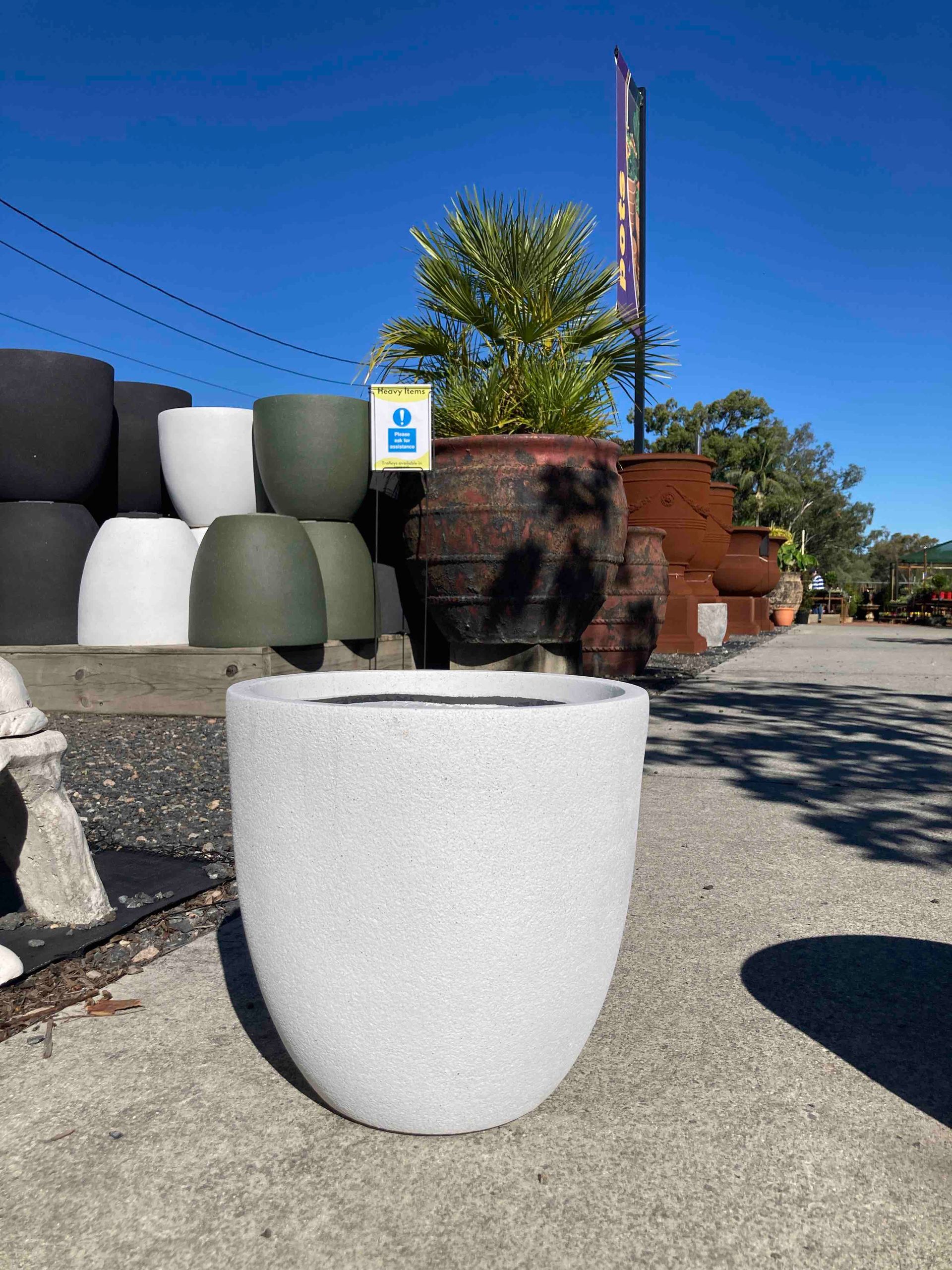 White planter pot on a outdoor patio