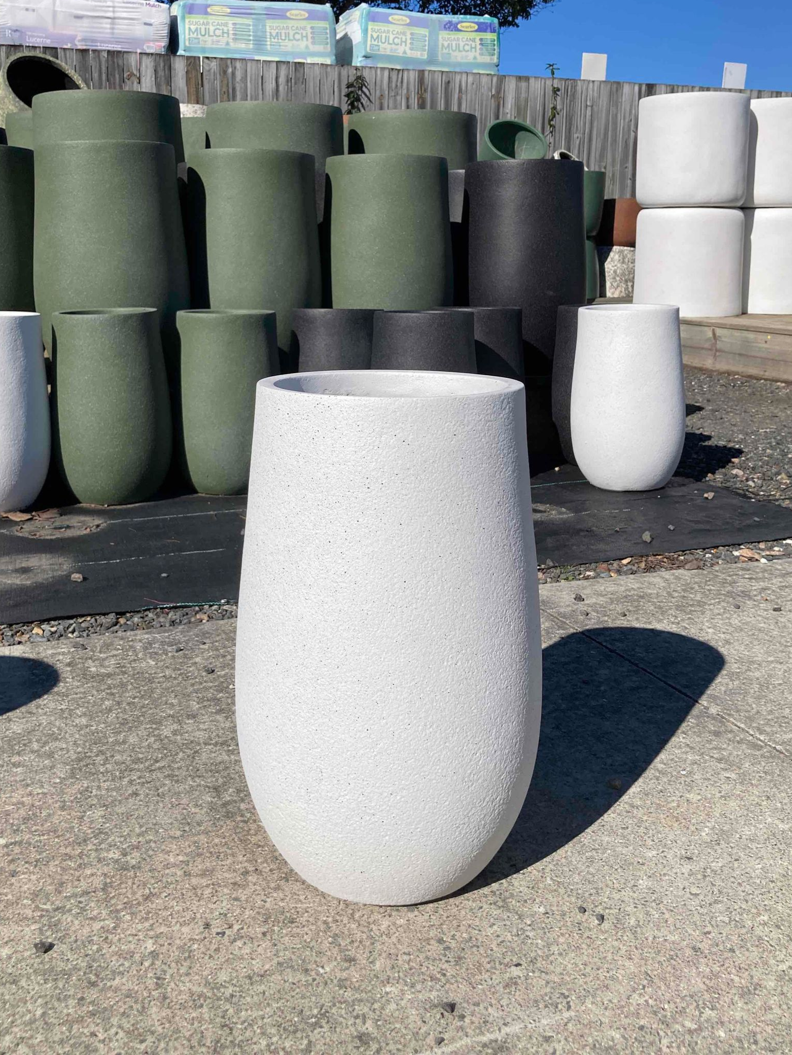White planter pot in front of an entrance green