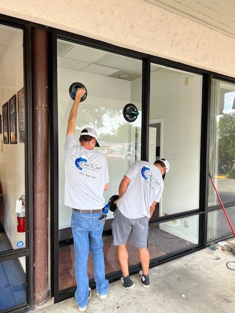 worker installing and adjusting aluminum frame sliding terrace doors
