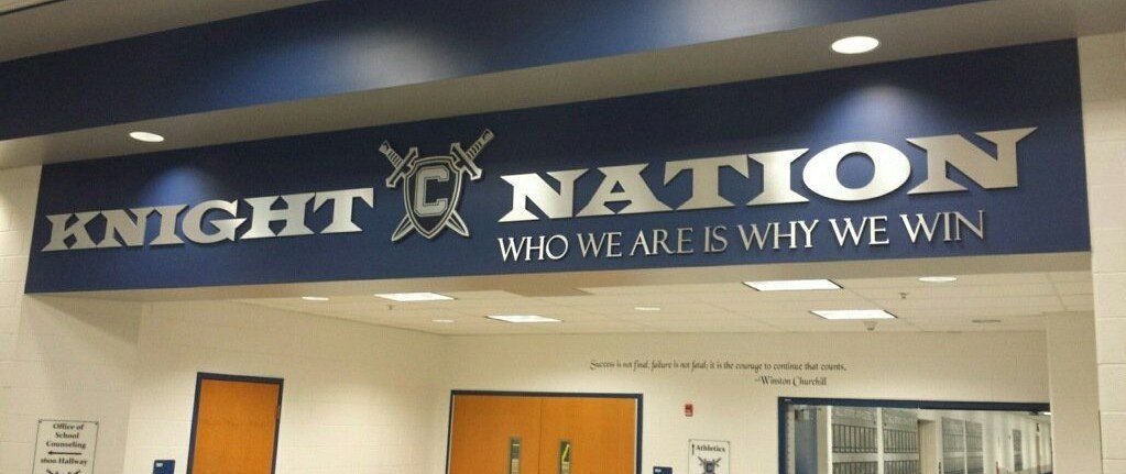 A blue sign that says knight nation who we are is why we win