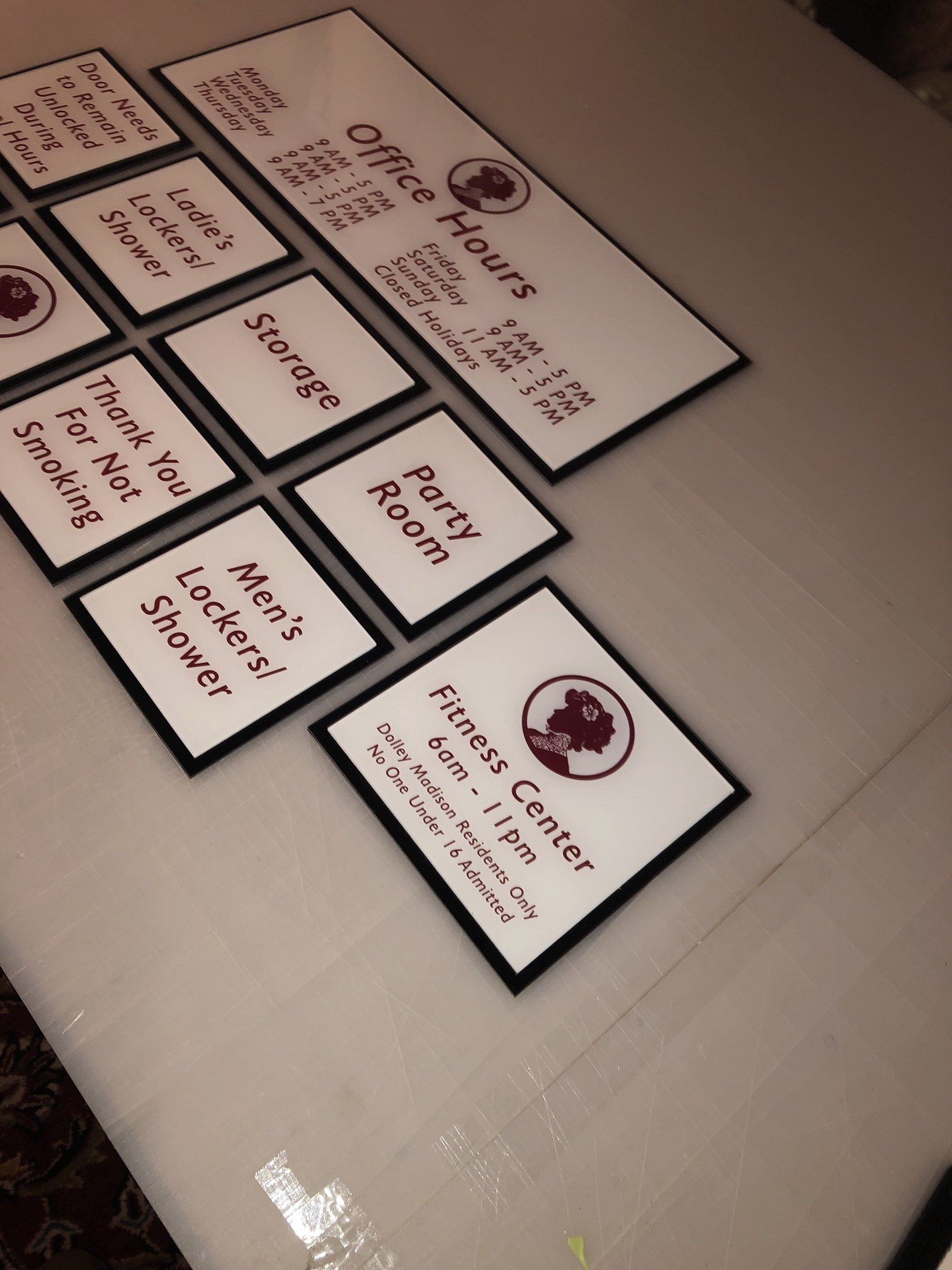 A bunch of signs on a table including one that says office hours