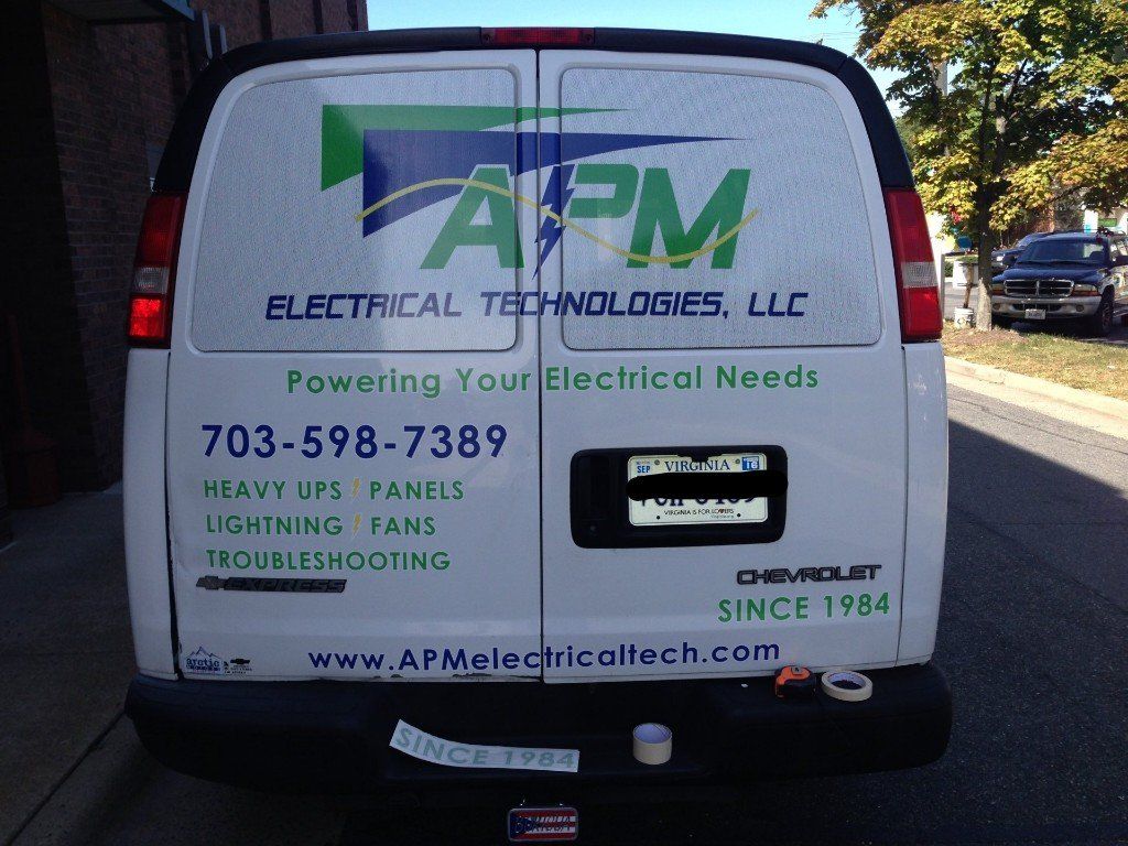 A white van with apm electrical technologies llc written on the back
