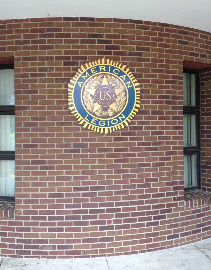 A brick wall with an american legion logo on it