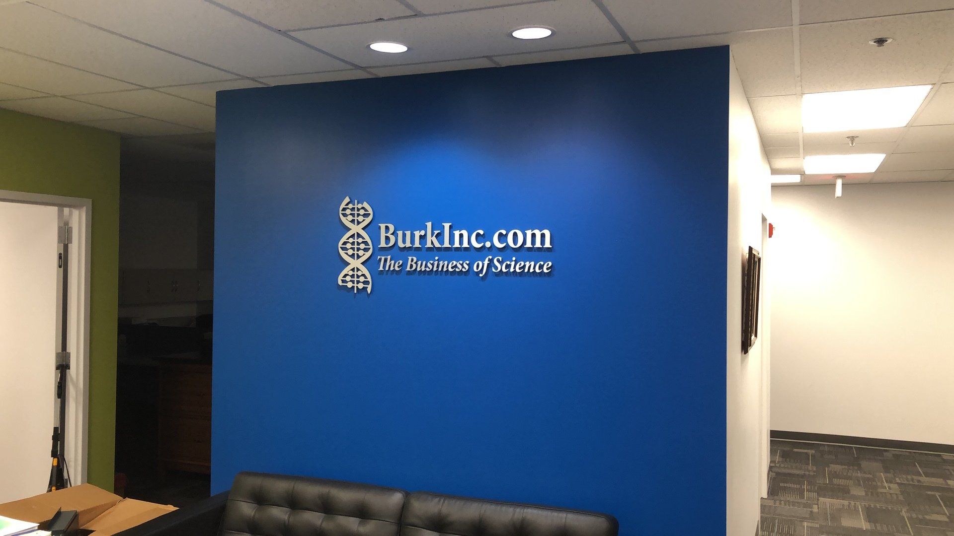 A blue wall with a sign that says burkinc.com