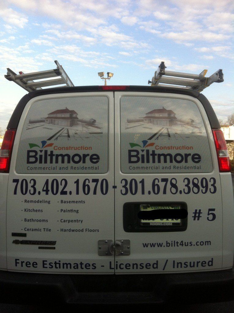 The back of a white van with billmore written on it