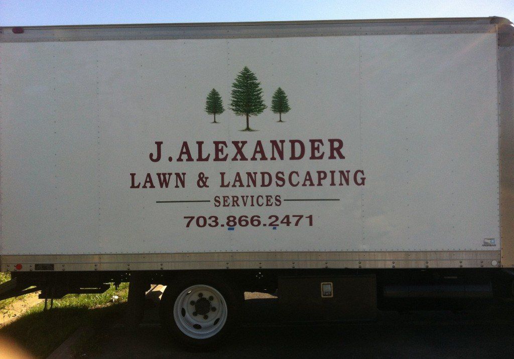 A j.alexander lawn and landscaping truck is parked in a parking lot