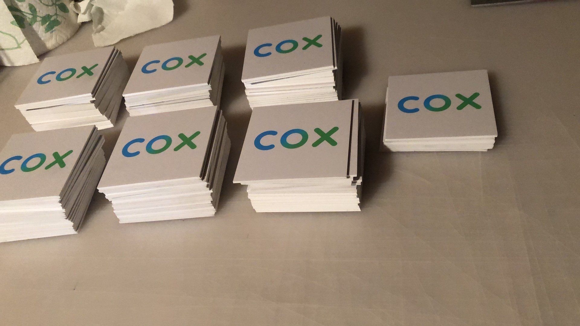 A stack of cox cards are sitting on a table.
