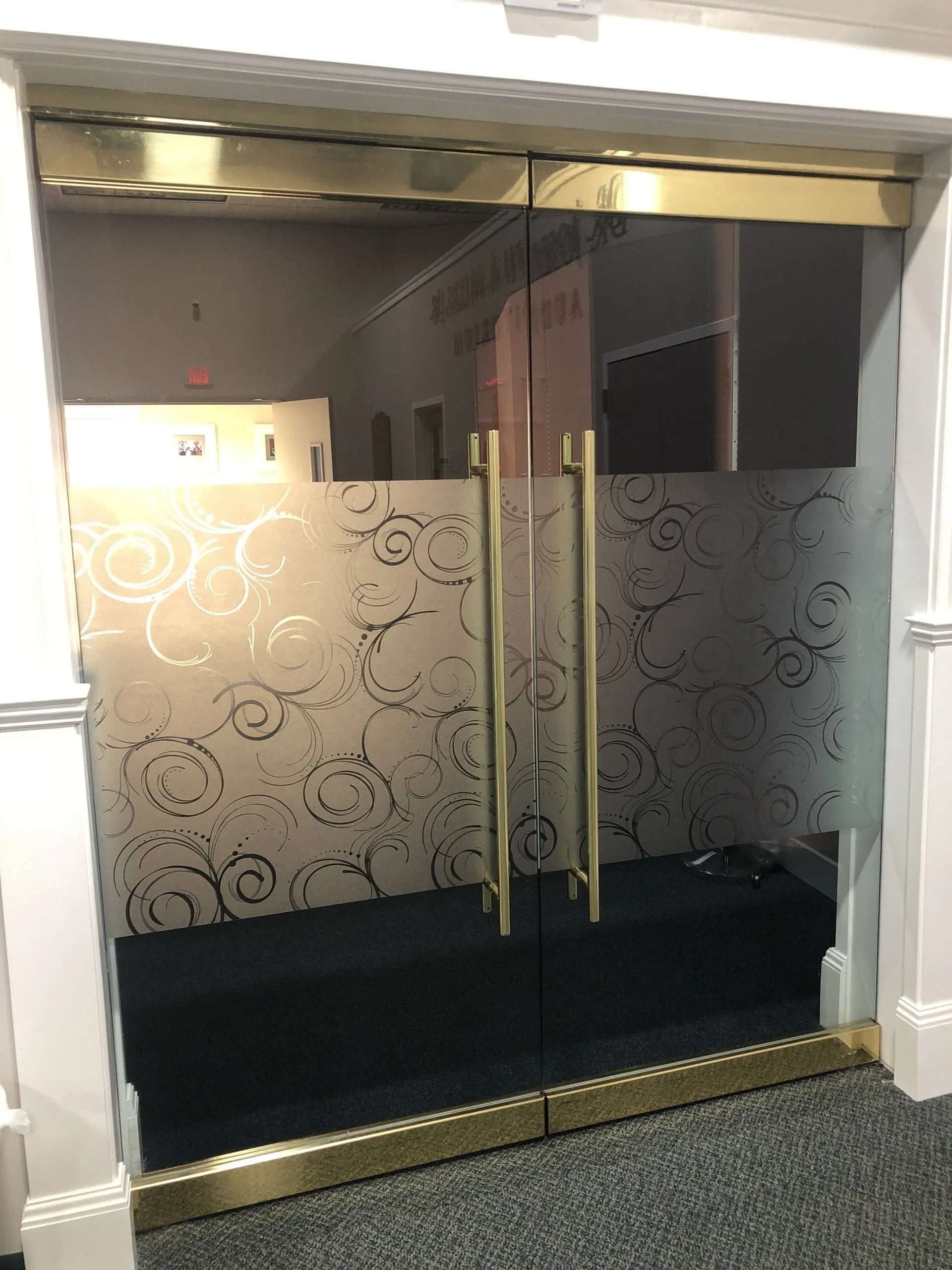 A glass door with a swirl pattern on it
