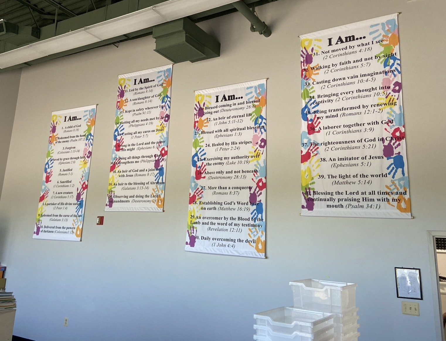 Three posters on a wall that say i am