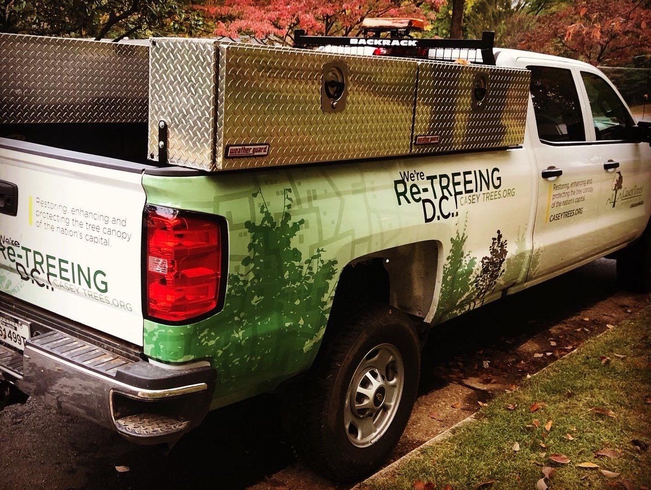 A white truck with the word re-treeing on it