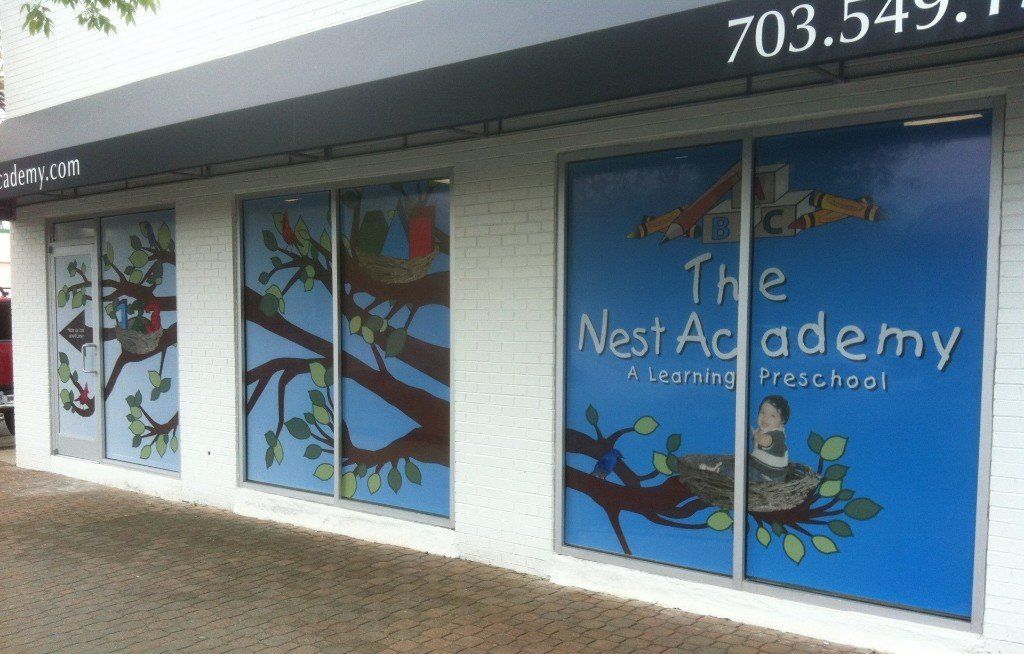 A building with a sign that says the nest academy
