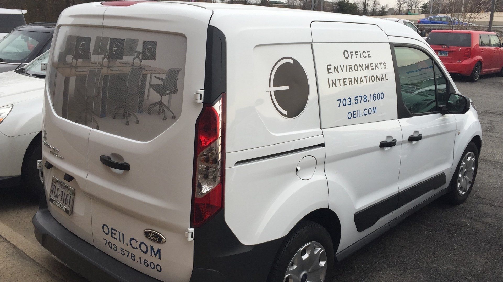 A white van is parked in a parking lot