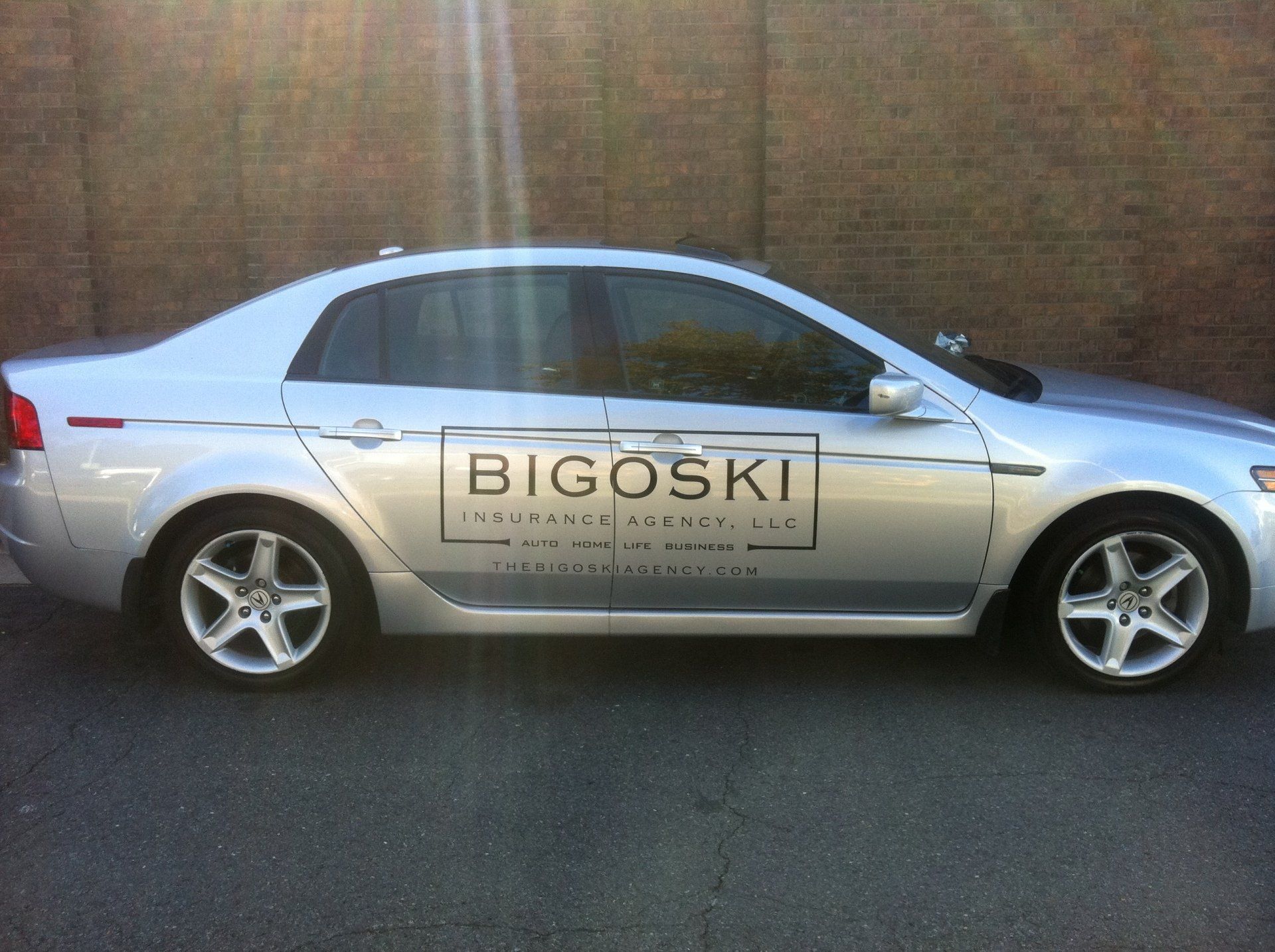 A silver car with bigoski written on the side