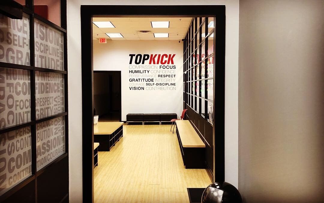 A hallway with a sign on the wall that says `` topkick ''.