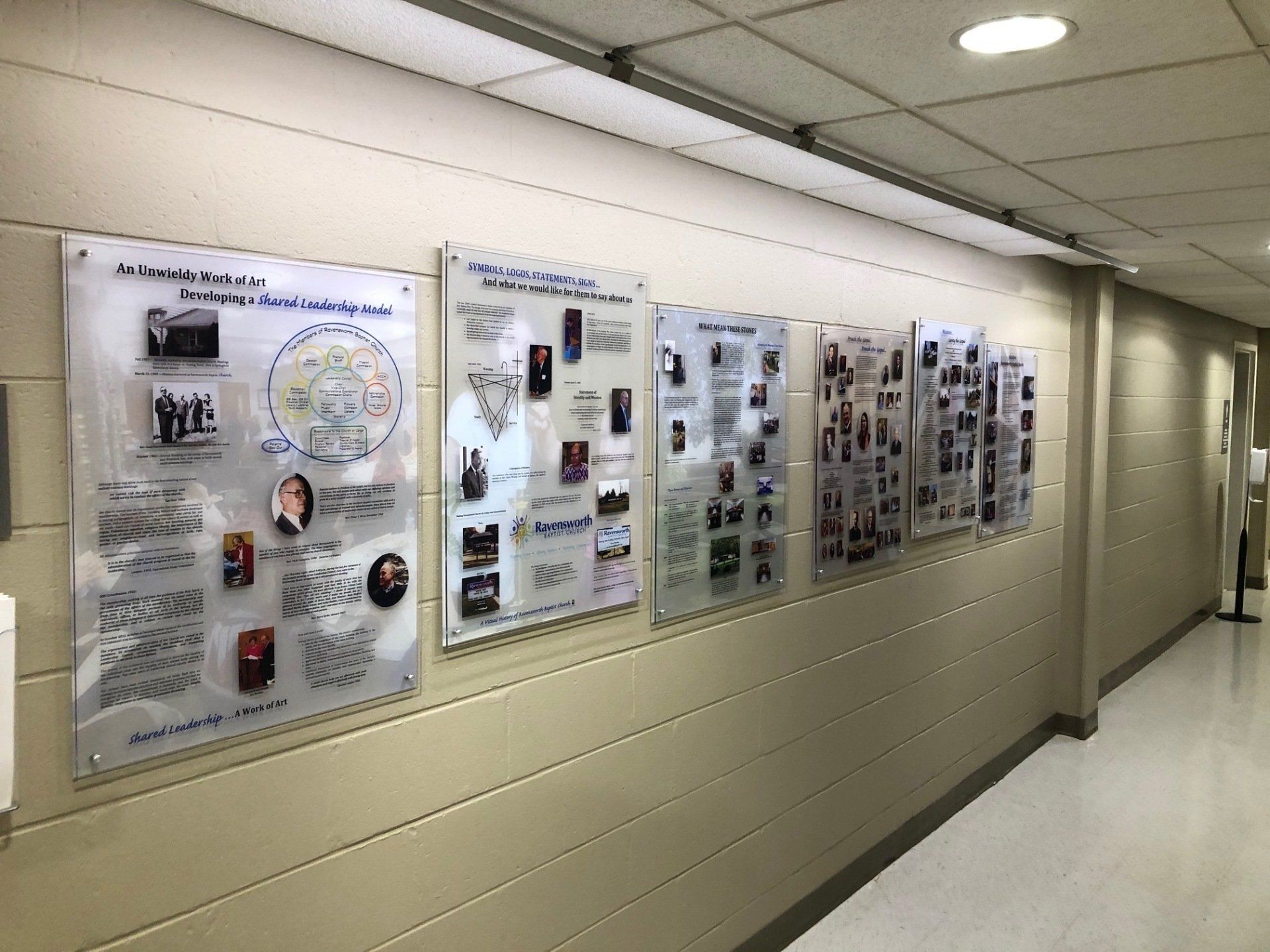 A hallway with a lot of posters on the wall.