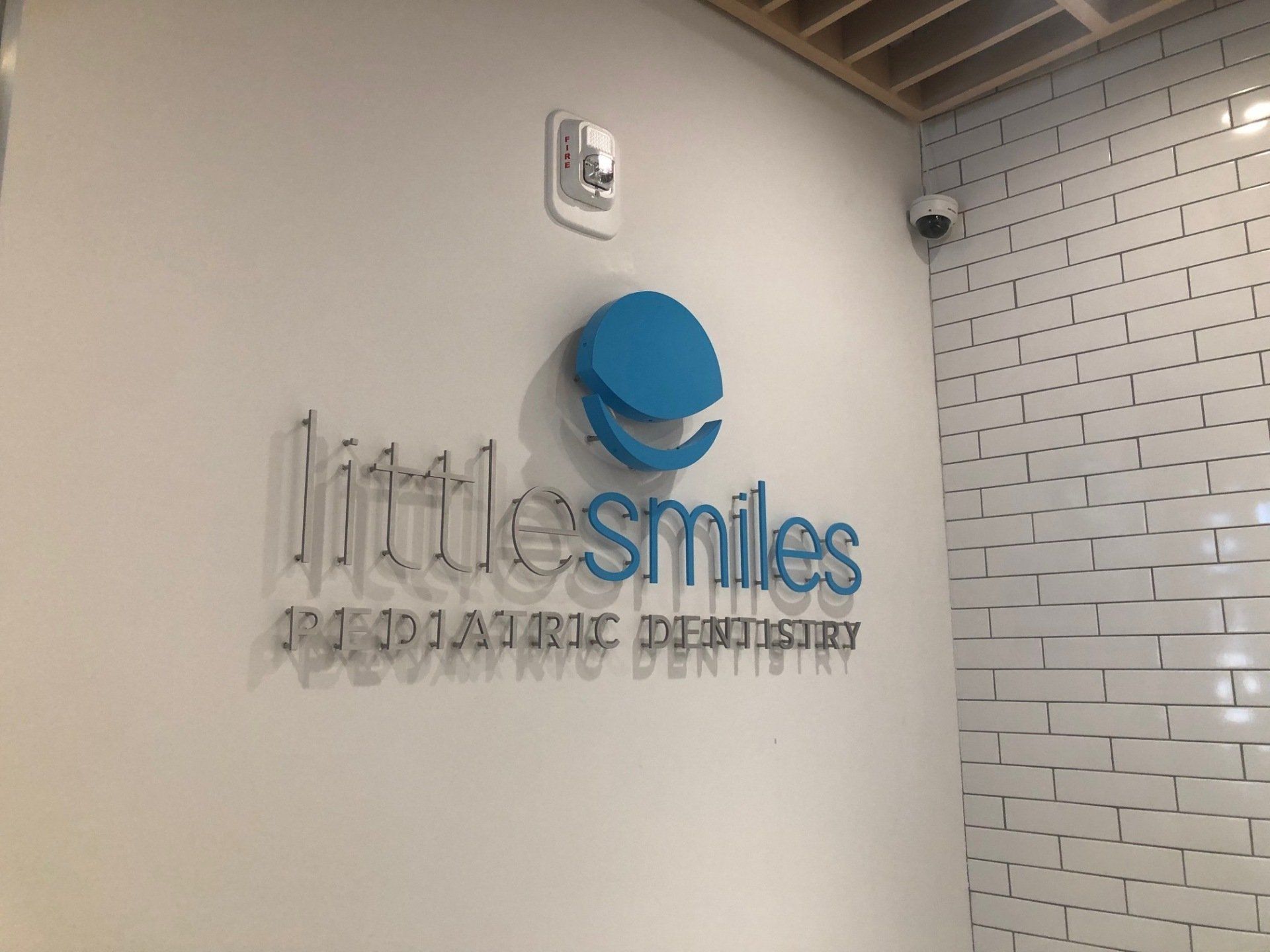 A little smiles pediatric dentistry sign on a wall