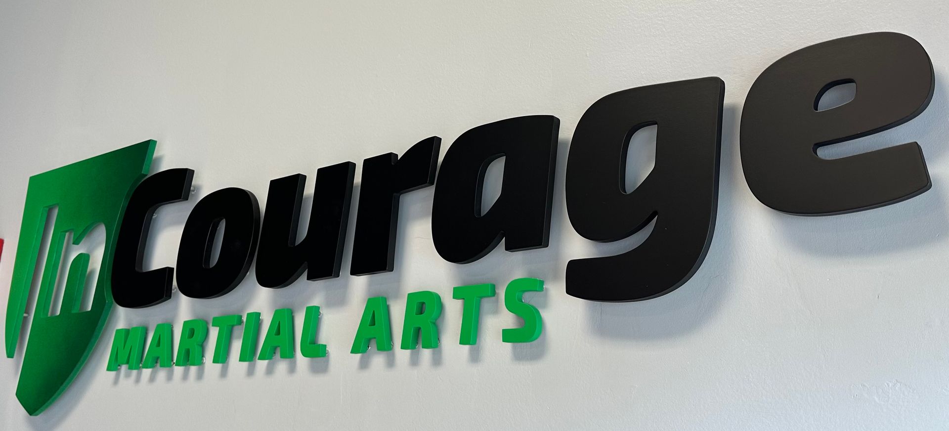 A sign that says courage martial arts on it