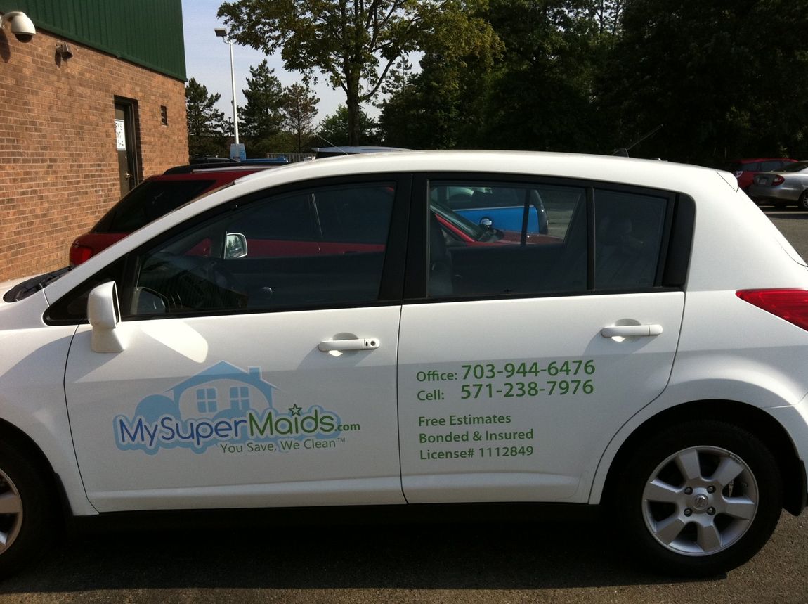 A white car with my super maids written on the side