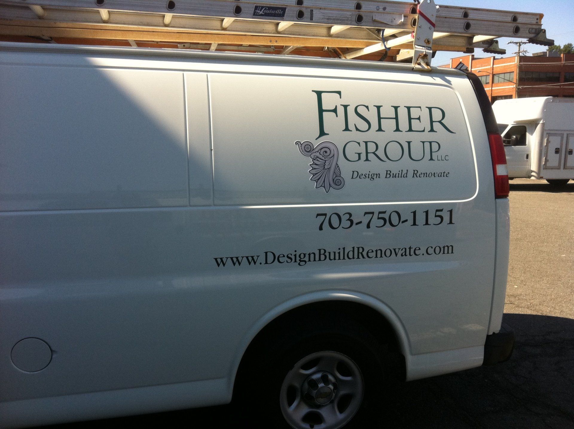 A fisher group van is parked in a parking lot