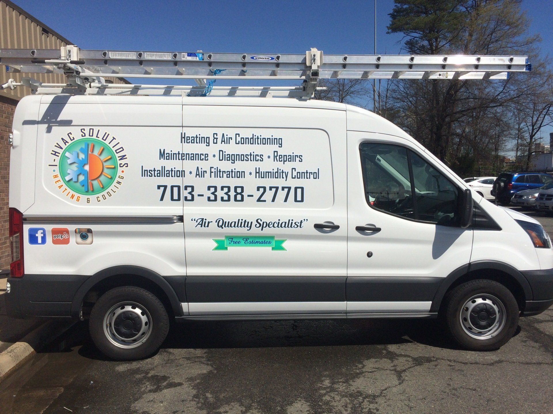 A white van with the number 703-338-2770 on it