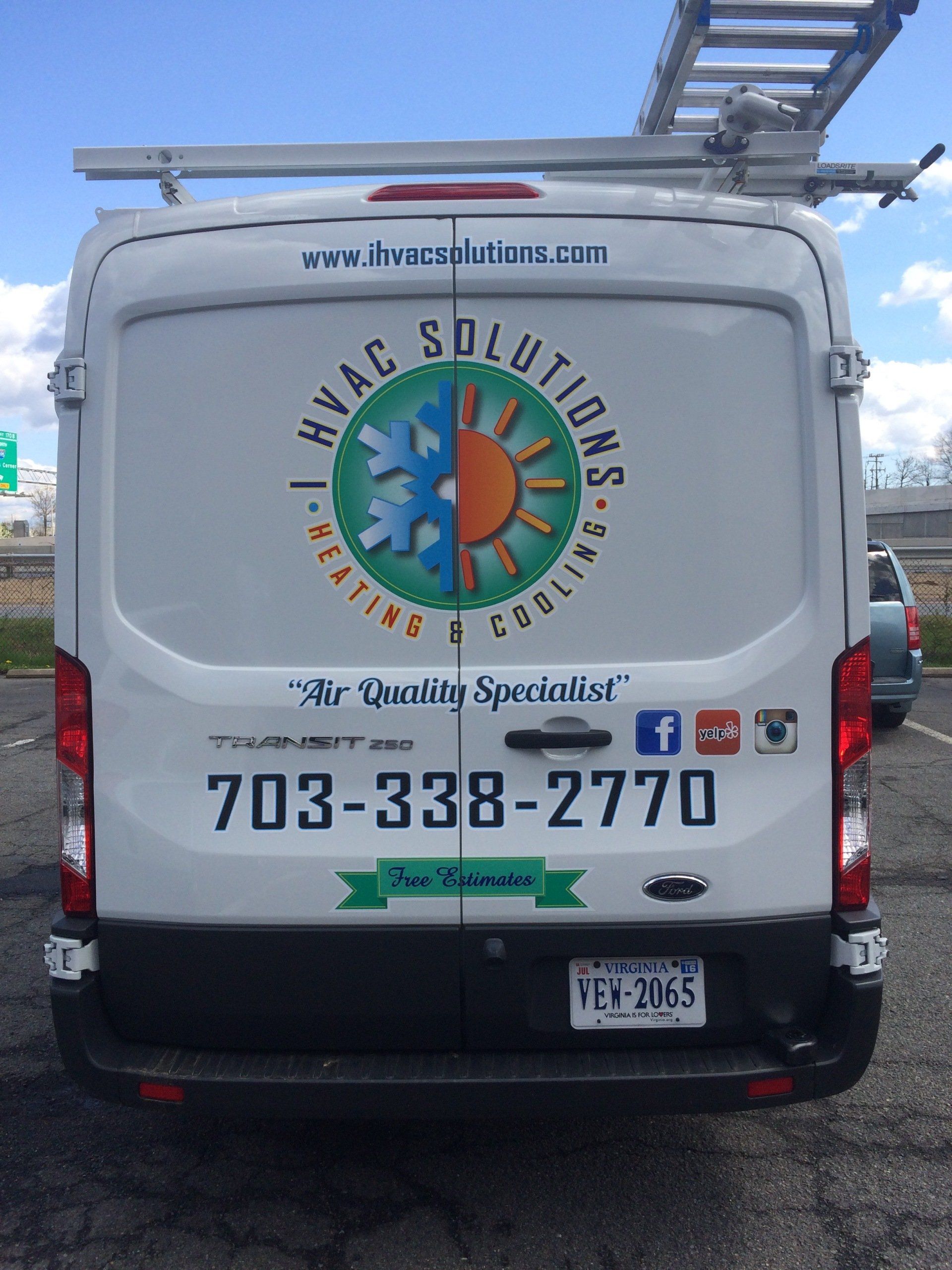 A white van with a logo for hvac solutions on the back
