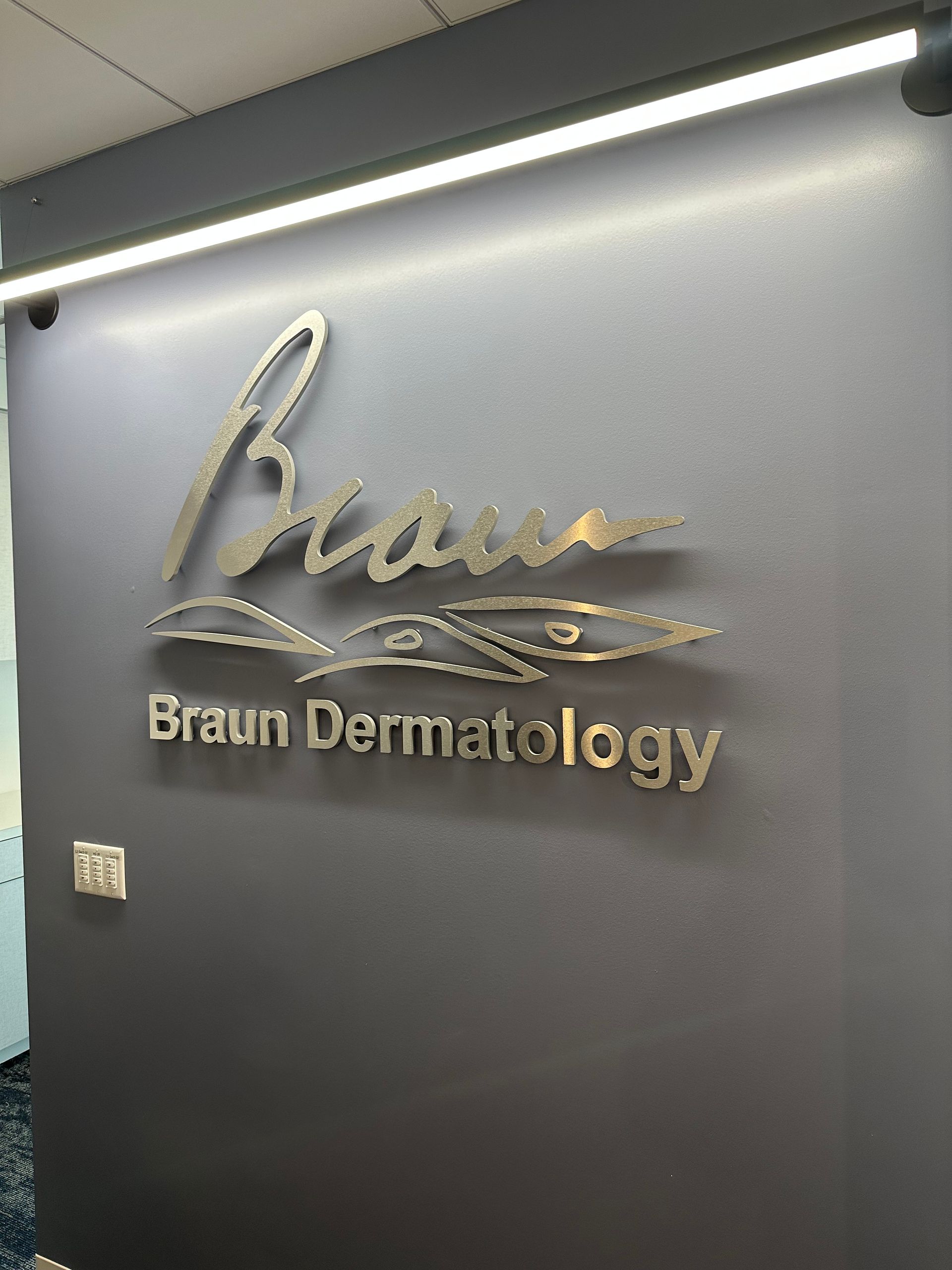 A sign on a wall that says braun dermatology