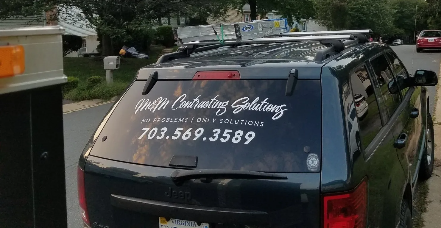 A black suv is parked on the side of the road