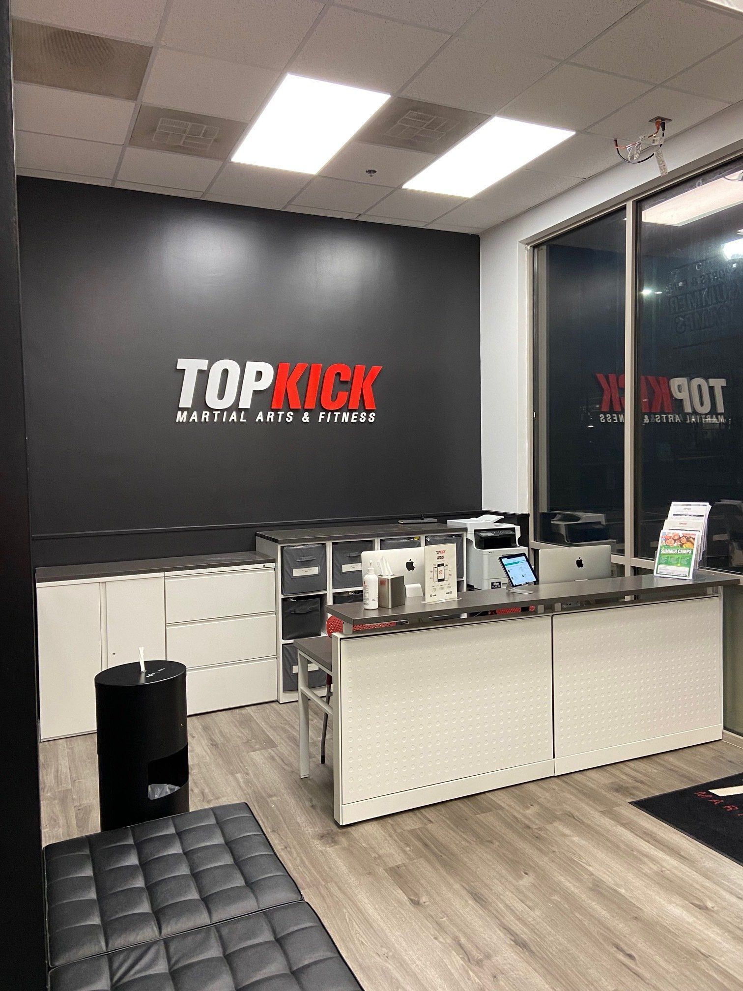 A room with a desk and a sign on the wall that says `` topkick ''.