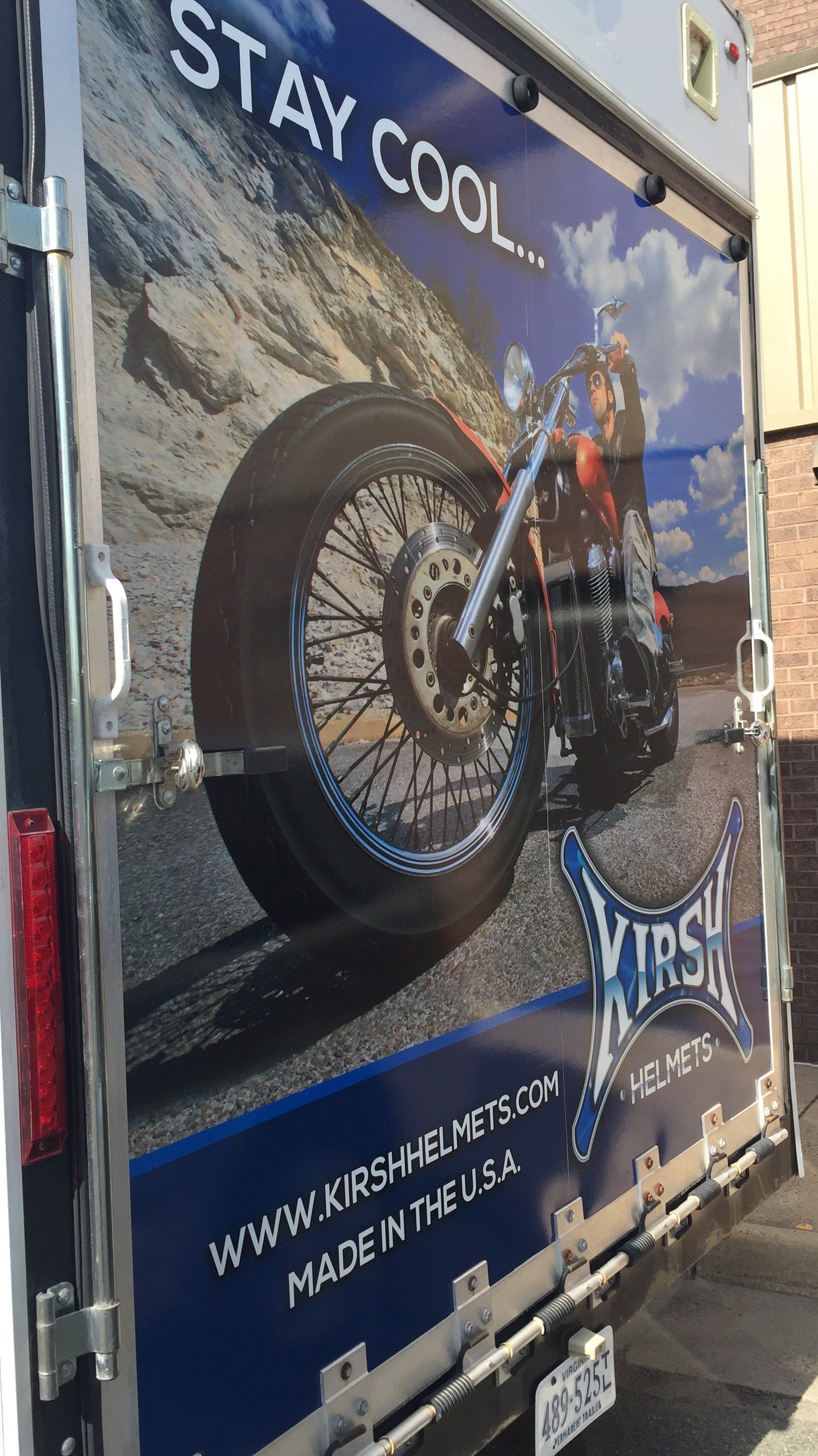 The back of a trailer with a picture of a motorcycle on it.